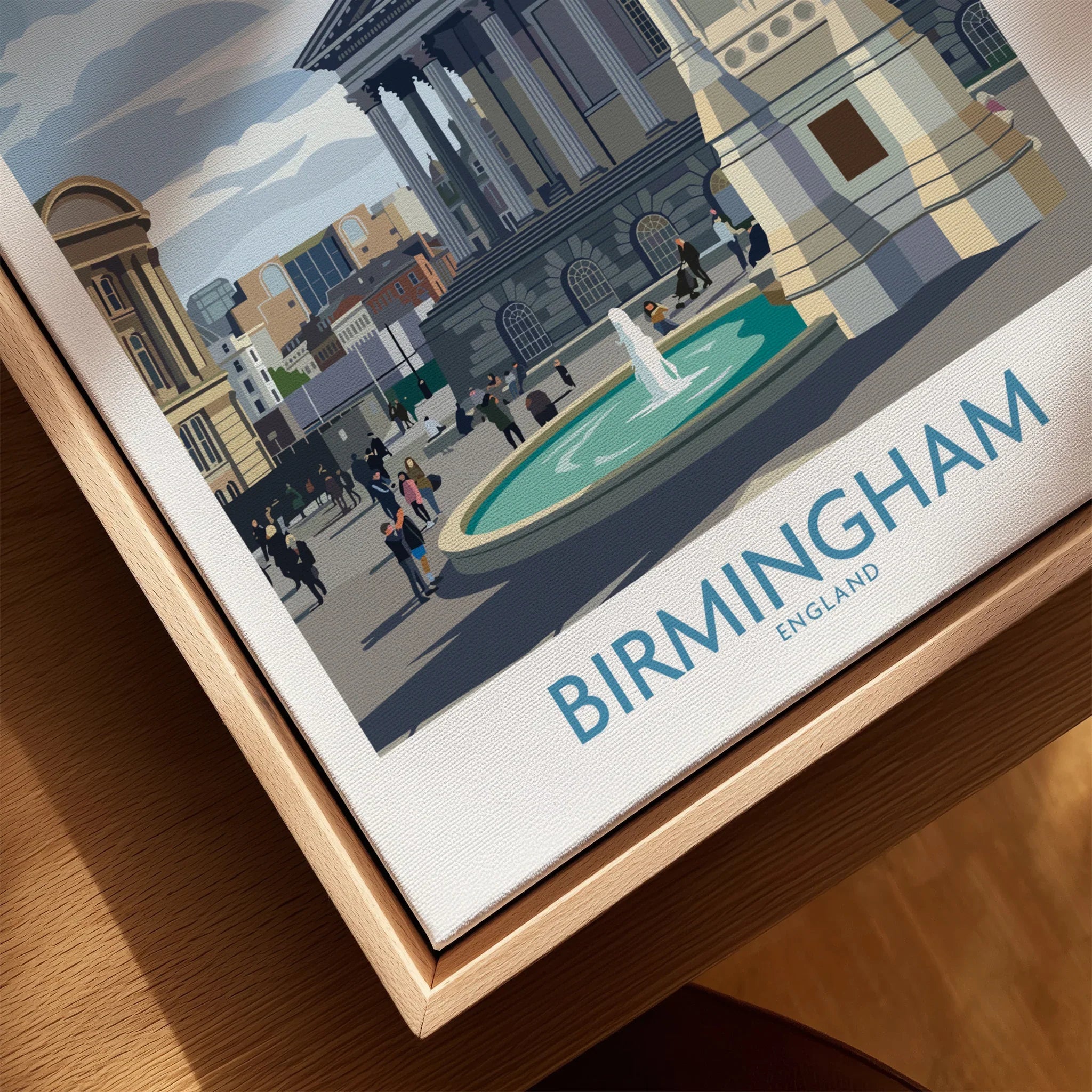 Closeup of framed Birmingham England cityscape wall art print with natural wood frame