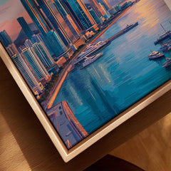 Close-up of framed city skyline wall art with modern buildings, marina, and natural wood frame
