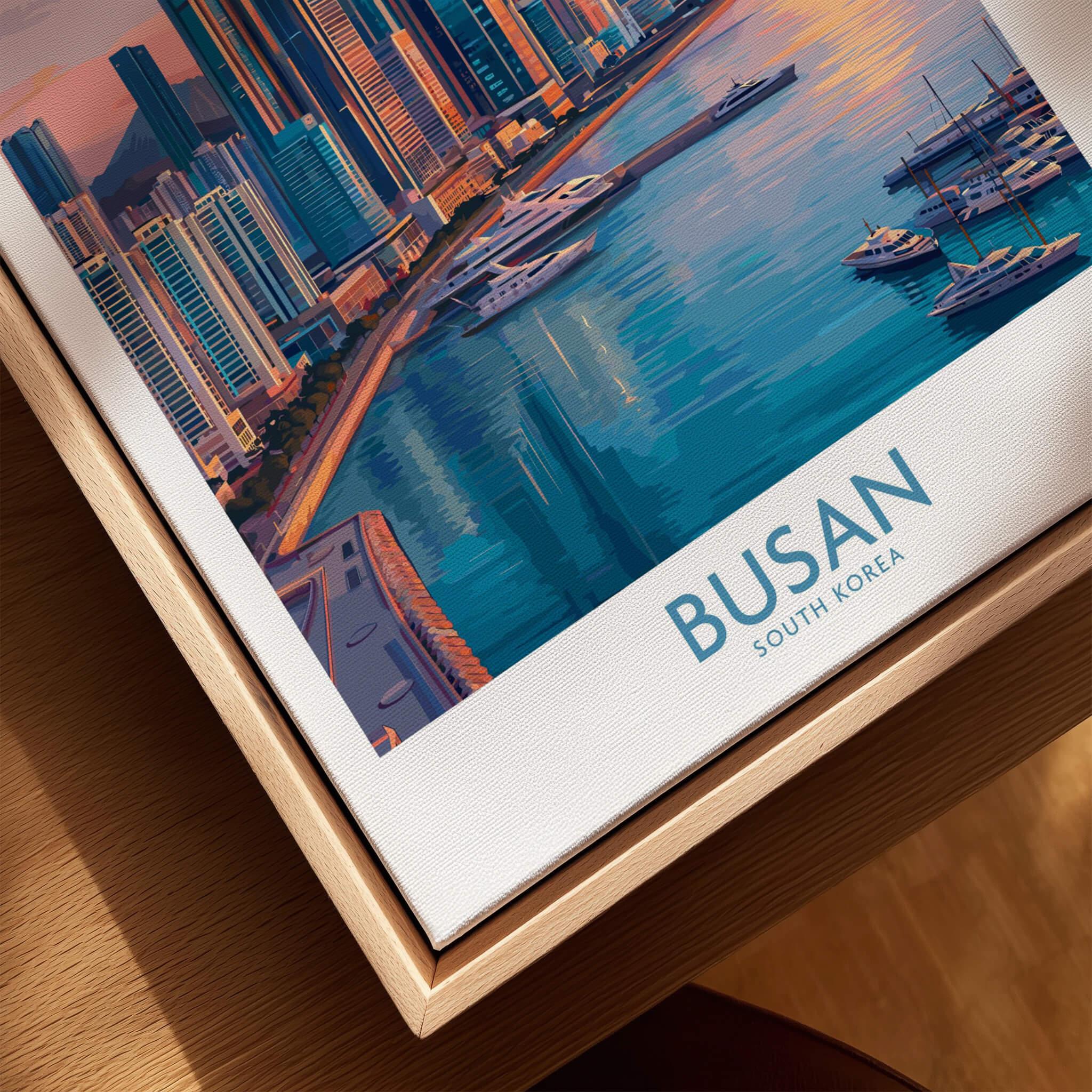 Close-up of framed Busan South Korea travel poster with city skyline and marina artwork