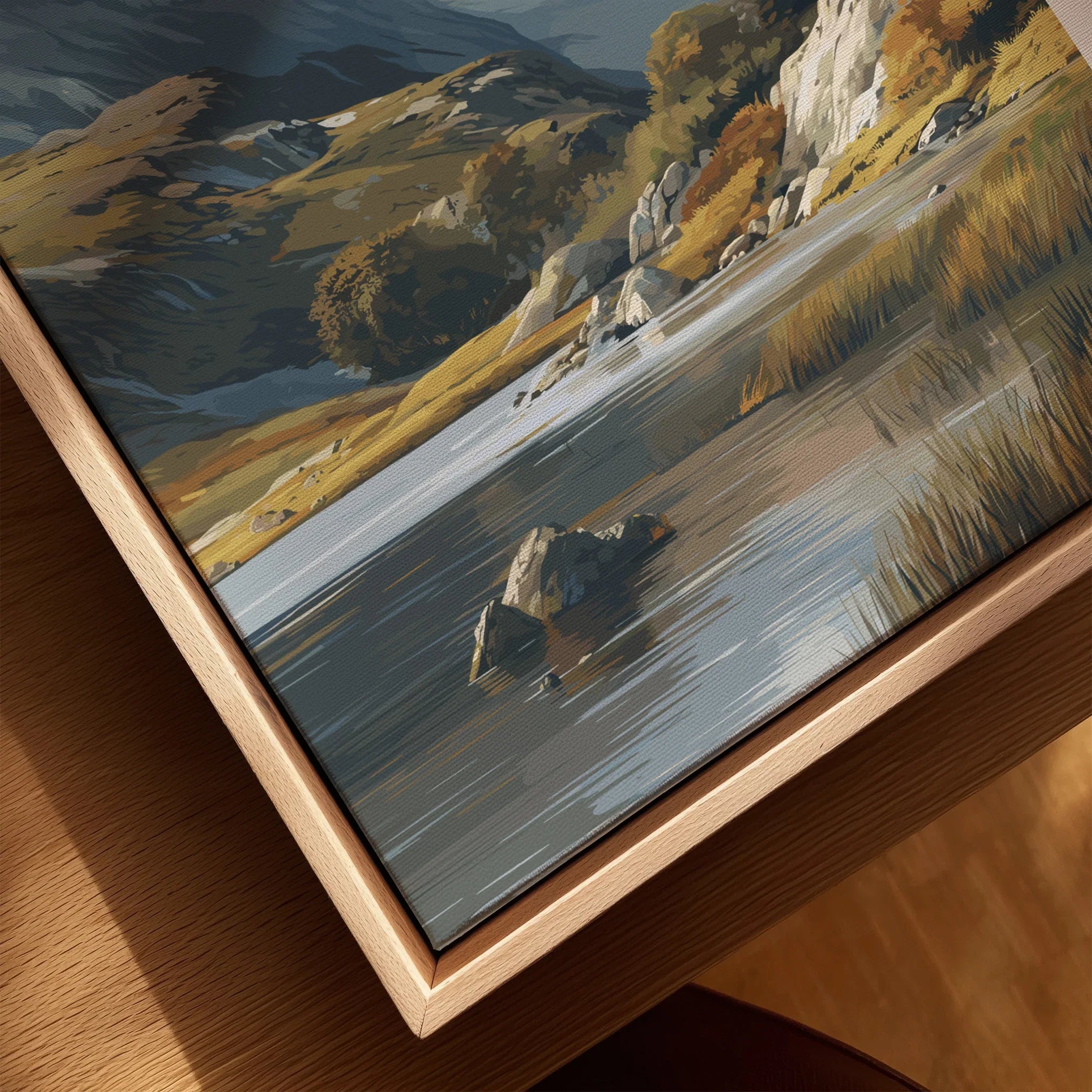 Close-up of landscape canvas wall art with natural wood floating frame, featuring lake, rocks, and hills.