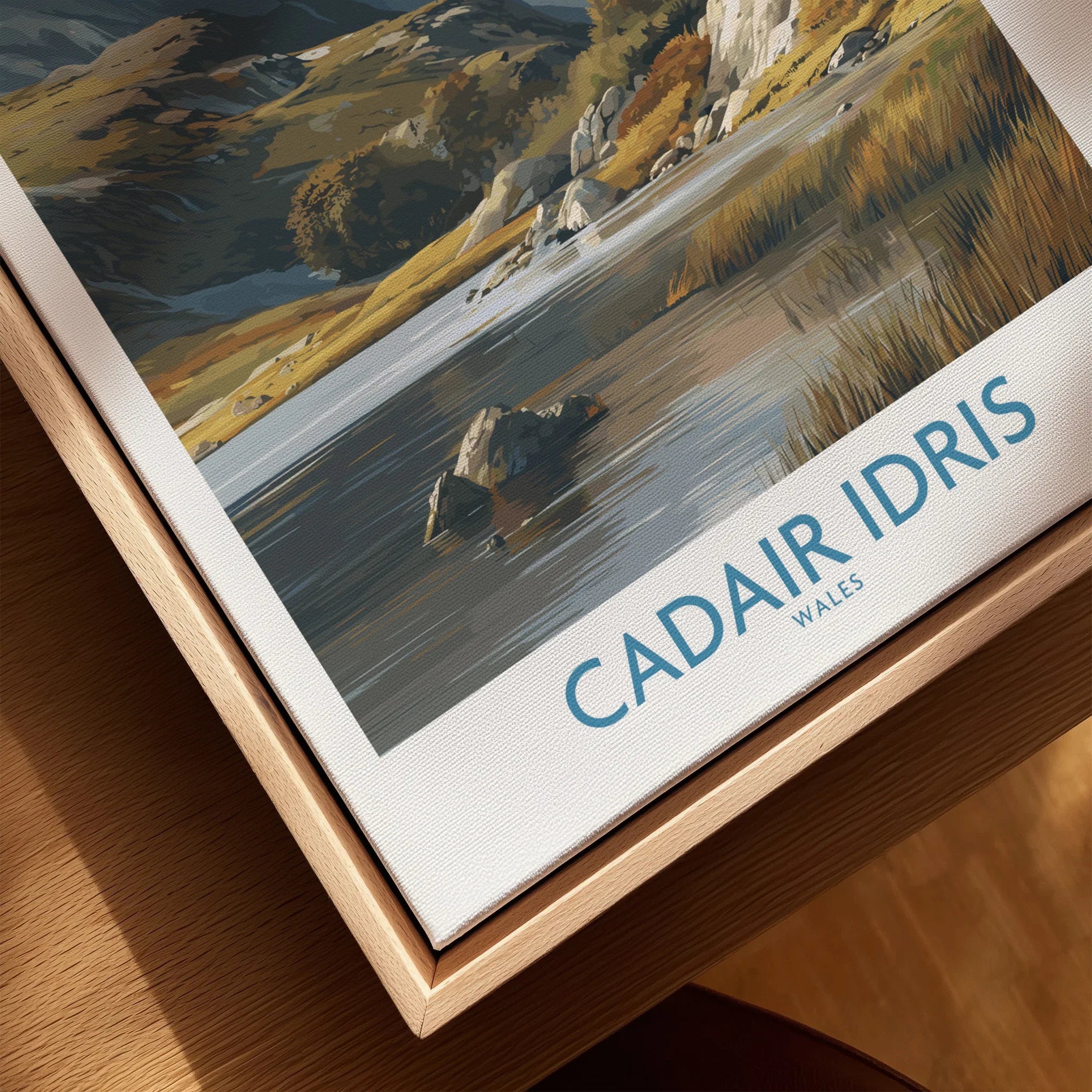 Close-up of framed canvas wall art featuring Cadair Idris landscape, natural wood frame.
