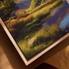 Close-up of framed canvas wall art depicting a colorful landscape with grass and a stream
