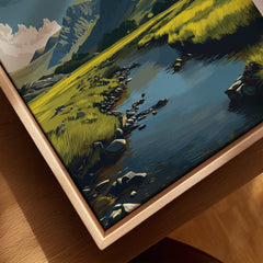 Closeup of framed canvas wall art featuring a mountain landscape with lake and grassy meadow.