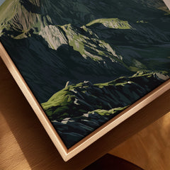 Close-up of mountain art print with natural wood floating frame on table
