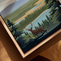 Closeup of framed canvas wall art with a deer silhouette and pine forest landscape