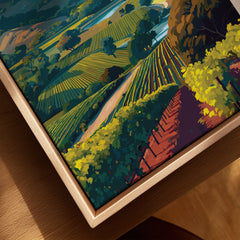 Closeup of framed canvas wall art featuring colorful hills and vineyards in a natural wood frame