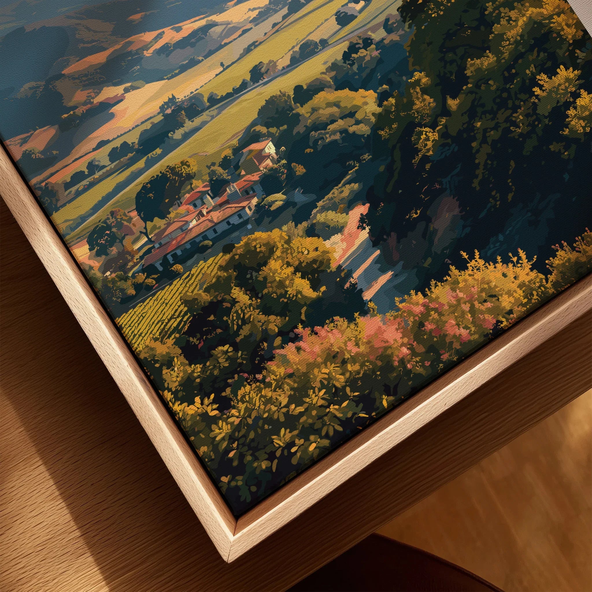 Closeup of framed canvas wall art with scenic countryside landscape and natural wood frame