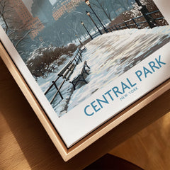 Framed Central Park winter art print with snowy path and benches, close-up view.