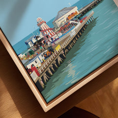 Clacton-on-Sea Travel Poster – Historic Pier Art Print showcasing the iconic pier with colorful buildings and seaside charm.