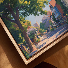 Closeup of framed canvas wall art featuring a scenic city street with trees and historic buildings.