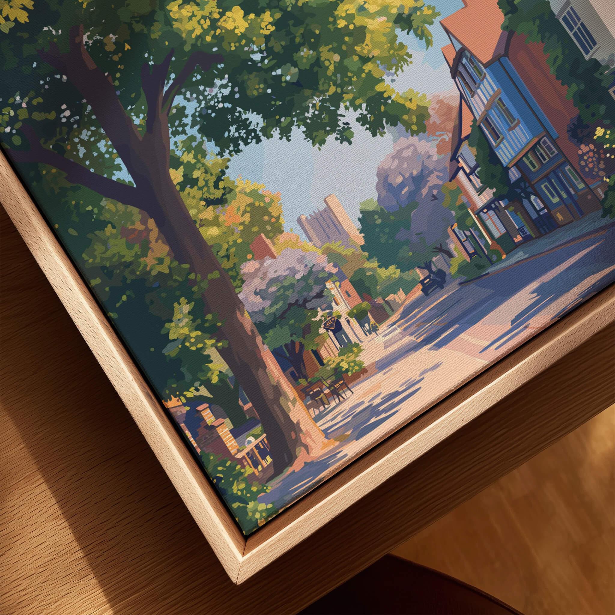 Closeup of framed canvas wall art featuring a scenic city street with trees and historic buildings.