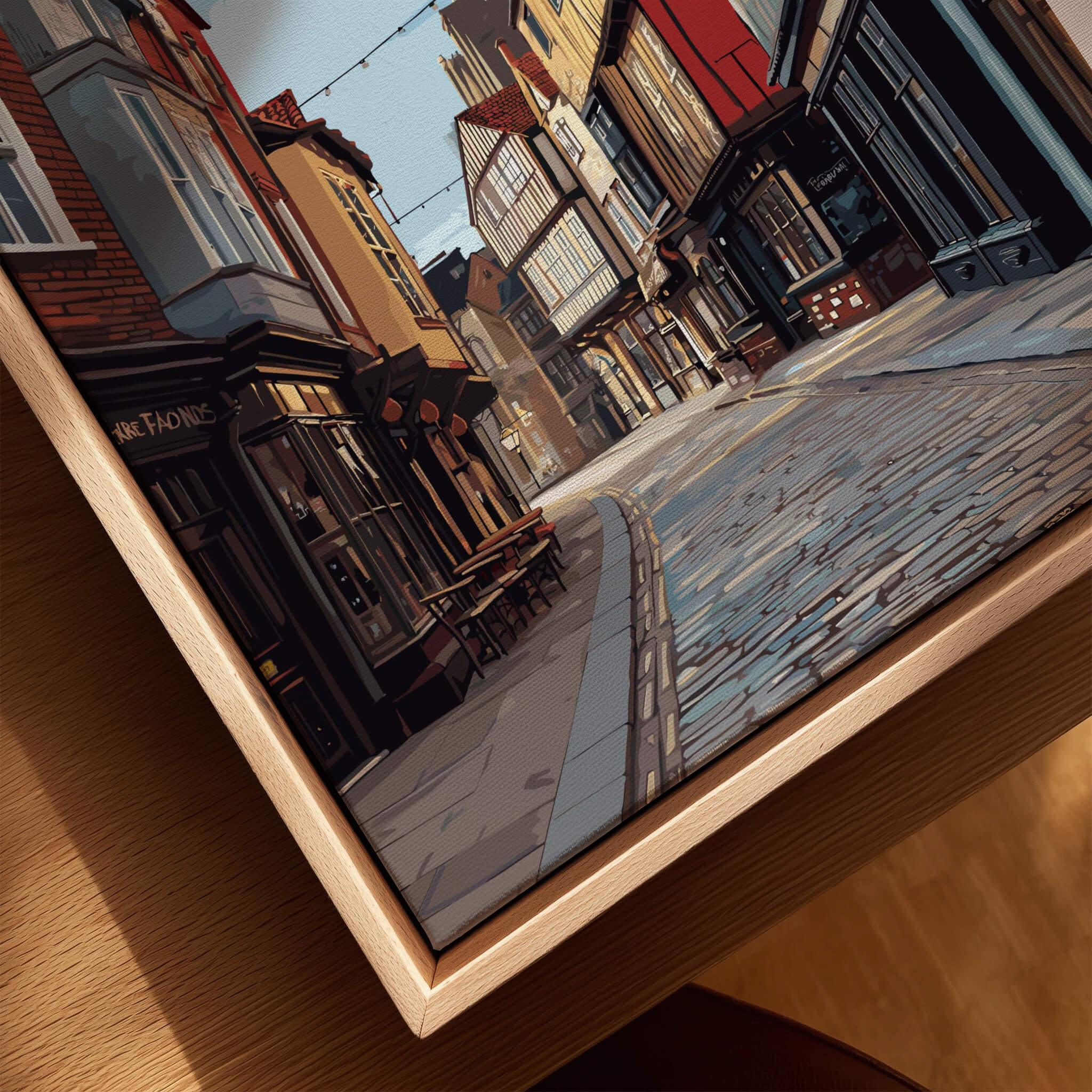 Close-up of framed city street art print with natural wood floating frame
