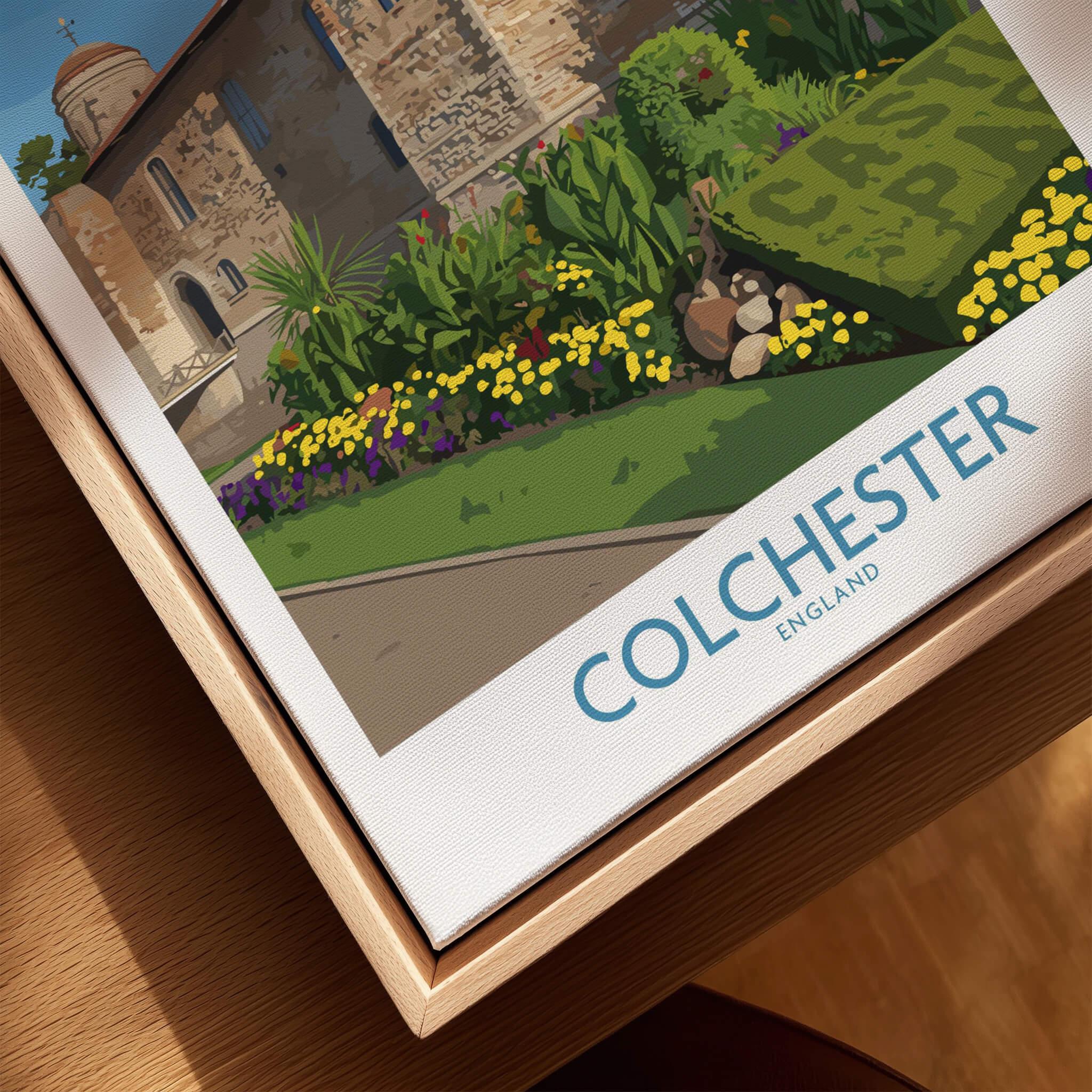 Close-up of Colchester England travel poster in natural wood floating frame with castle and gardens.