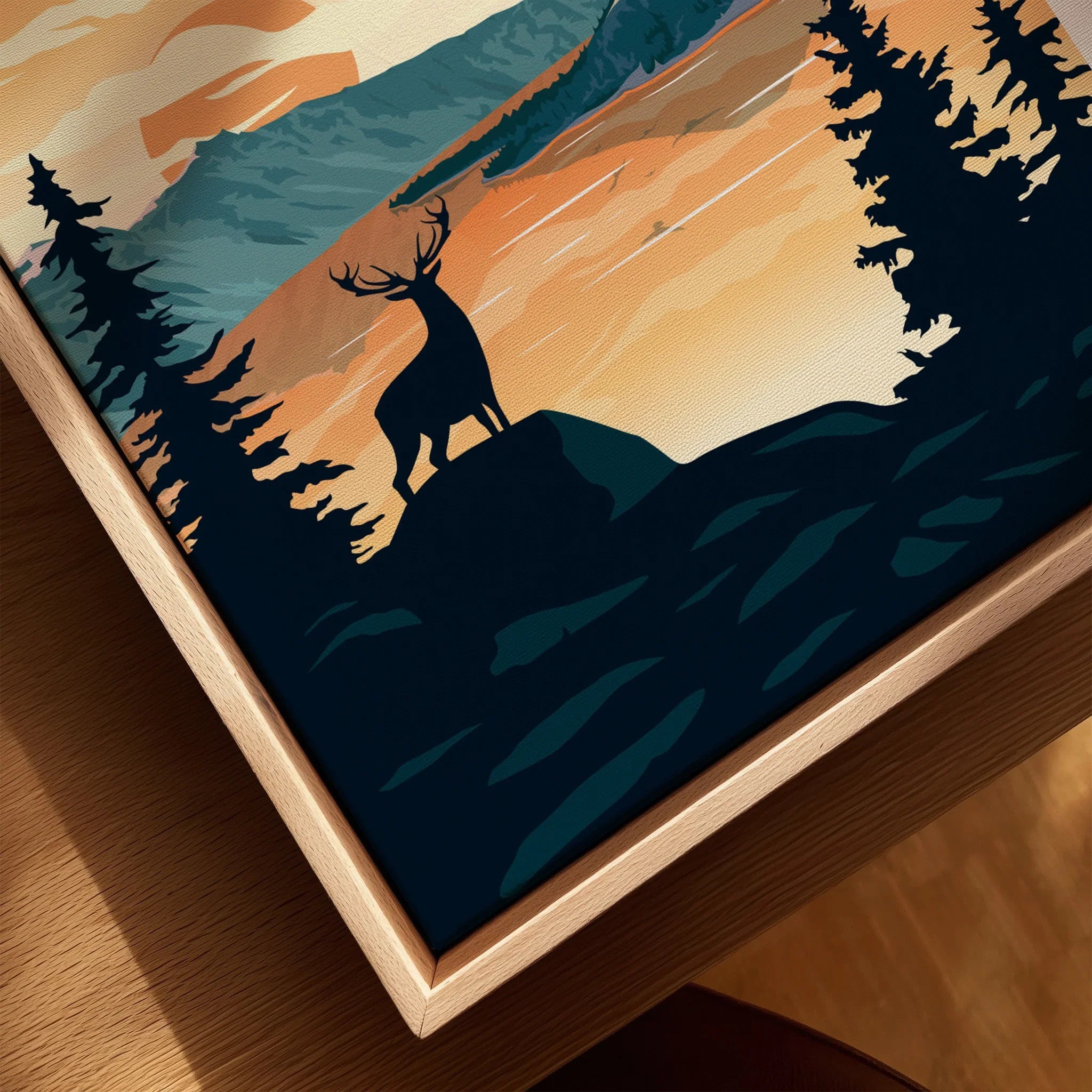 Closeup of framed canvas wall art with deer silhouette and sunset forest landscape
