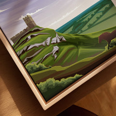 Close-up of framed Dartmoor travel poster with stylized green hills, castle, and horse