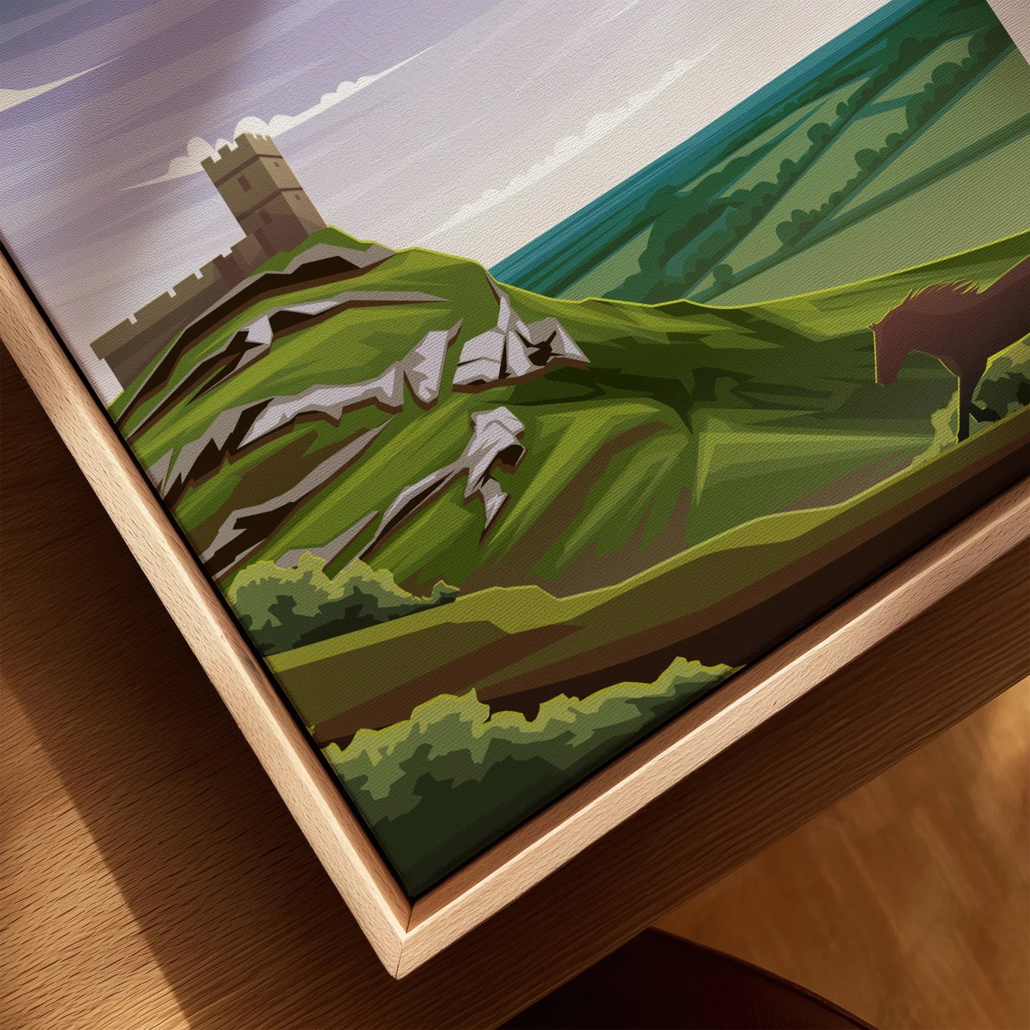 Close-up of framed Dartmoor travel poster with stylized green hills, castle, and horse