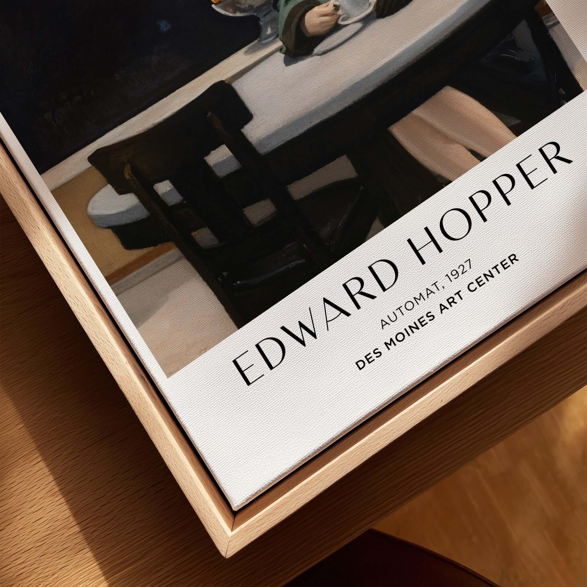 Edward Hopper Automat 1927 Des Moines Art Center Poster Print displayed on a wooden table with a cup of coffee.