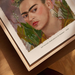 Frida Kahlo Self Portrait Dedicated Dr Eloesser Floral Poster Art Print displayed in a wooden frame.