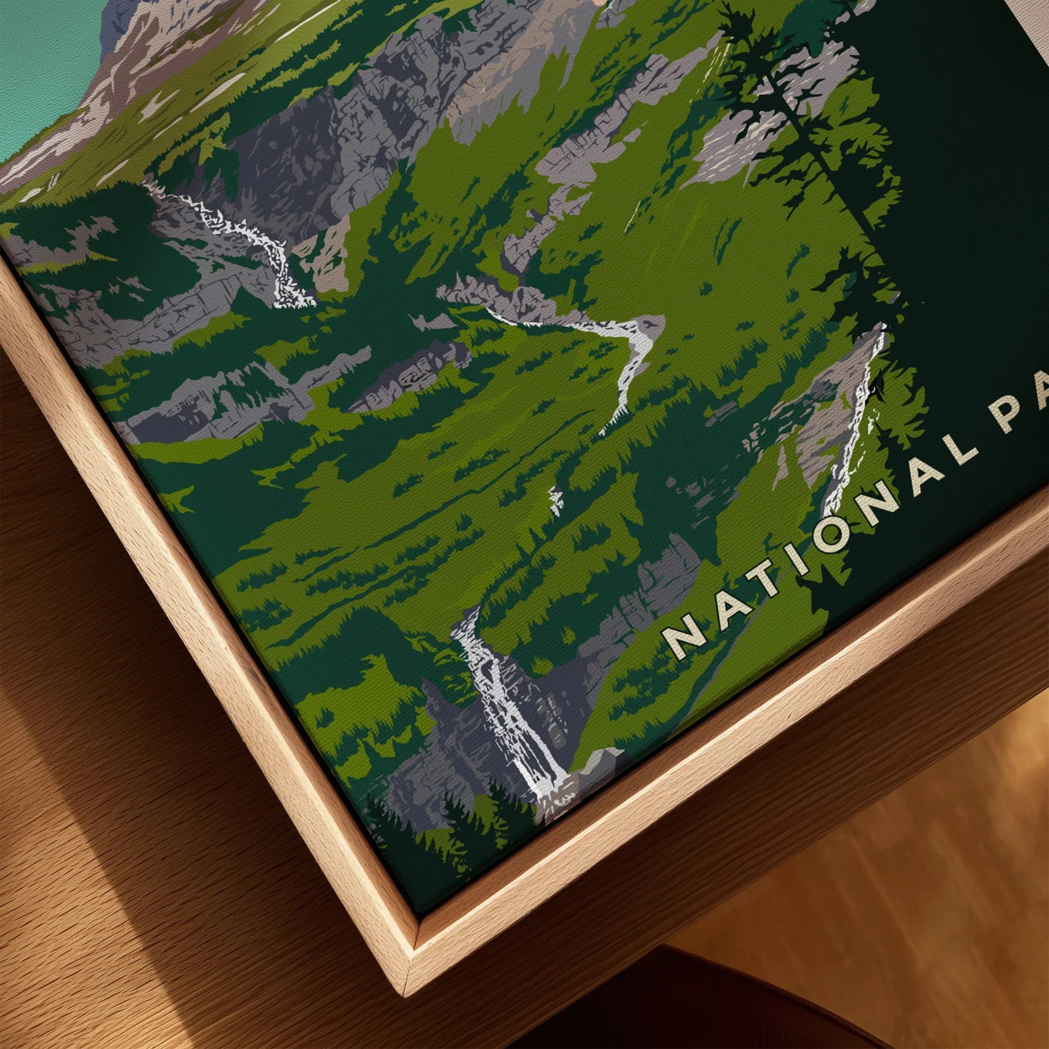 Closeup of Glacier National Park print with green landscape and waterfall in natural wood frame