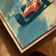 Closeup of framed canvas wall art featuring vintage red race car, natural wood floating frame