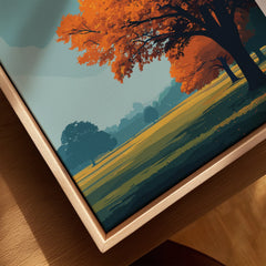 Close-up of framed canvas wall art with autumn landscape and natural wood floating frame