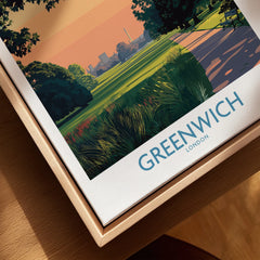 Close-up of a framed Greenwich London travel poster in natural wood floating frame