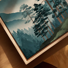 Closeup of canvas wall art with misty forest landscape in natural wood floating frame