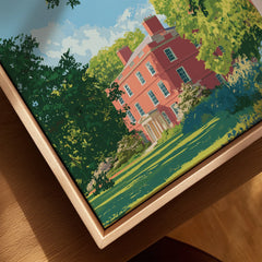 Closeup of framed canvas art featuring a red historic building and lush green gardens.