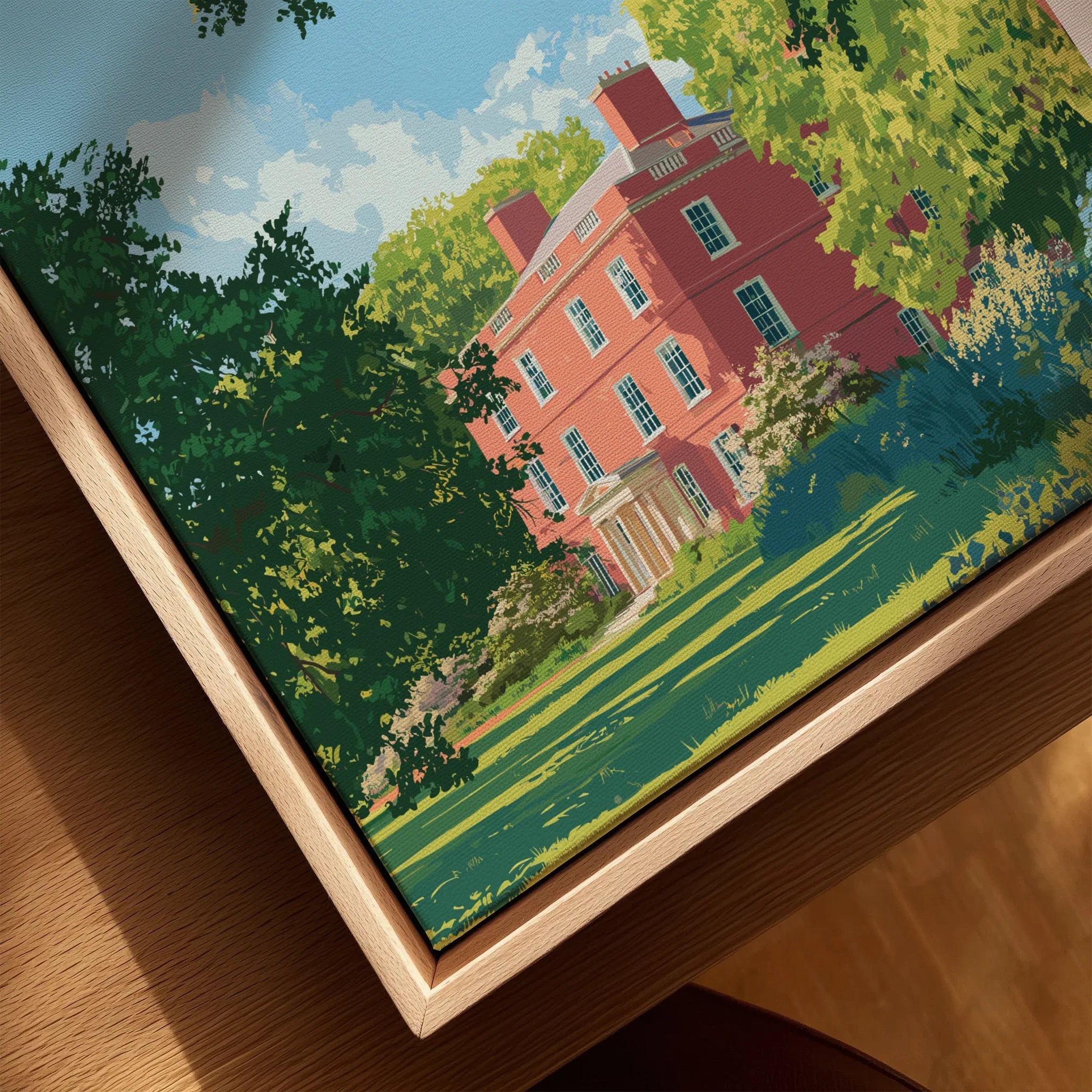 Closeup of framed canvas art featuring a red historic building and lush green gardens.