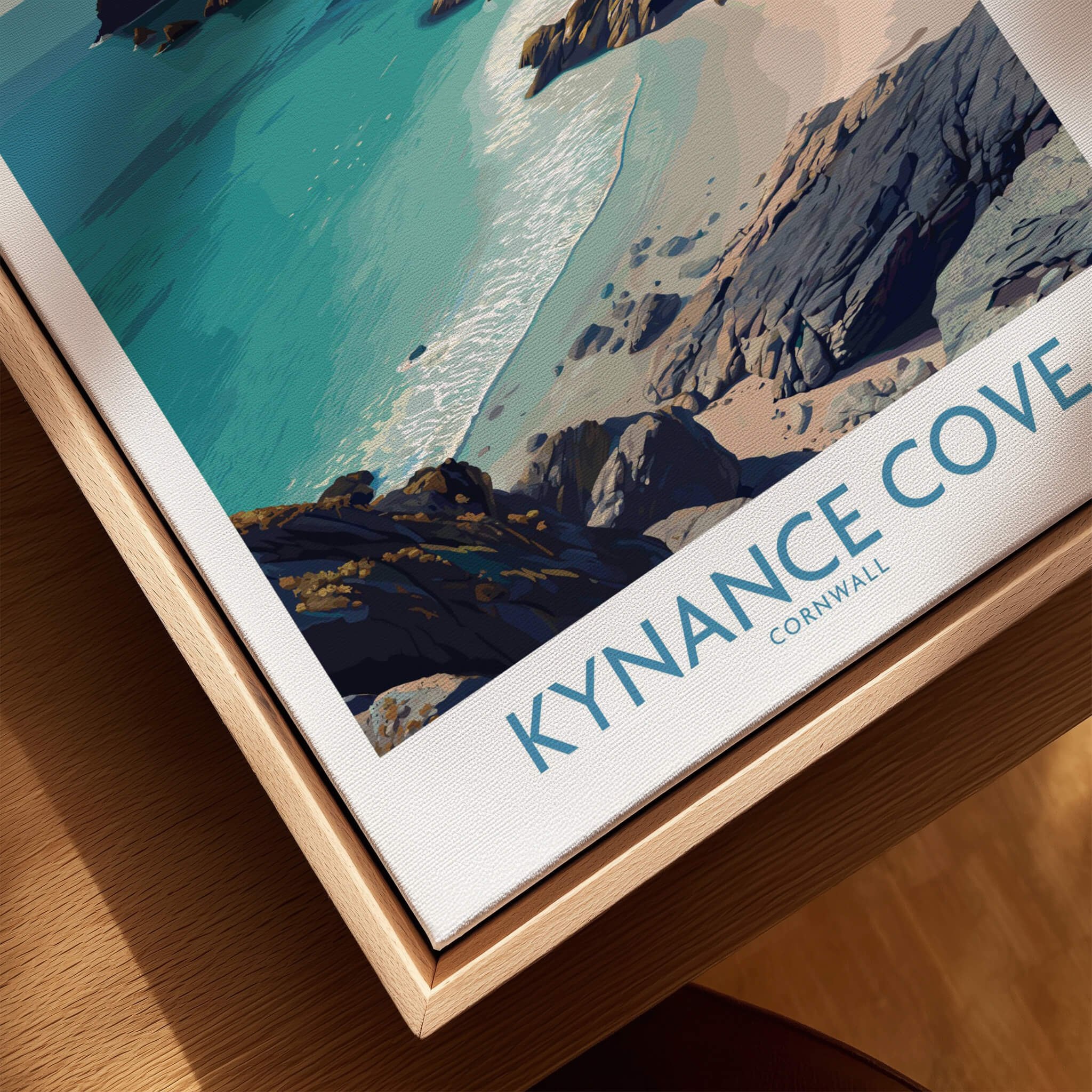 Kynance Cove Cornwall Poster | Scenic Sea Cliffs & Beach Canvas Print displayed on a wooden surface.