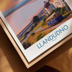 Framed canvas wall art of Llandudno, Wales, featuring a tram and coastal scenery.