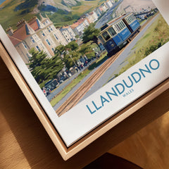 Framed canvas print of Llandudno Wales travel poster with vintage tram and seaside scene