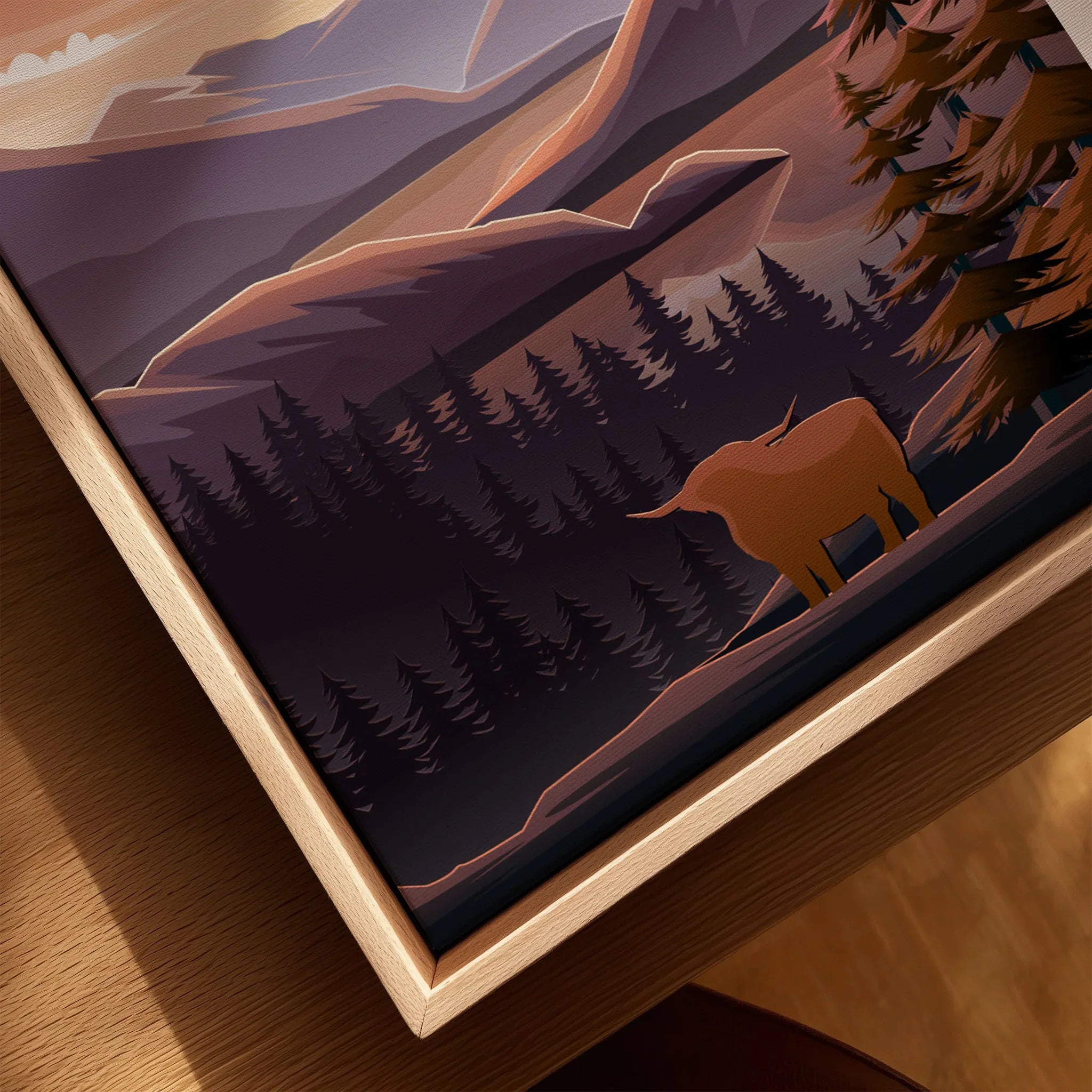 Closeup of framed canvas wall art featuring a highland cow, pine trees, and mountain landscape.