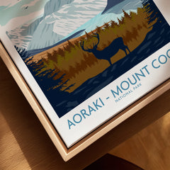 Closeup of Aoraki Mount Cook National Park travel poster in a natural wood floating frame