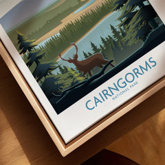 Framed Cairngorms National Park travel poster with deer, forest and lake detail.