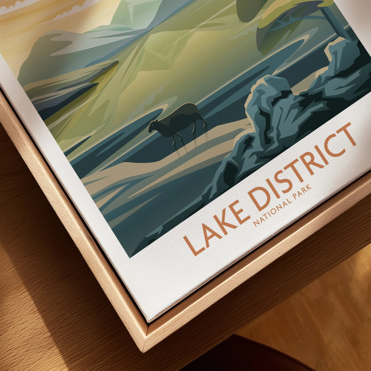 Close-up of Lake District National Park travel poster on canvas with natural wood floating frame