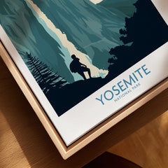 Closeup of Yosemite National Park travel poster framed in natural wood, featuring hiker silhouette.