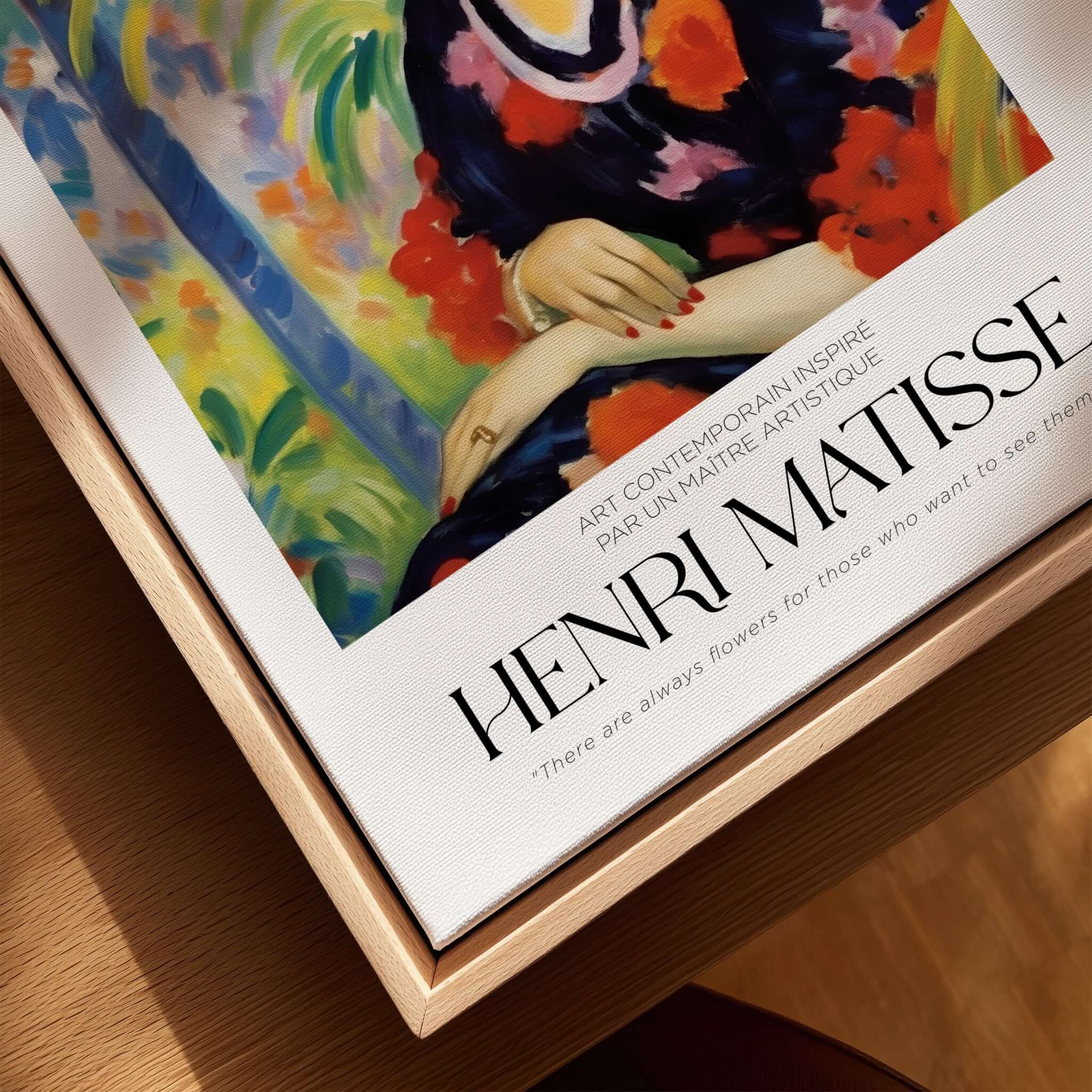 Matisse Art Prints - Woman with Blue Hat Garden Poster displayed on a wooden surface featuring colorful art.