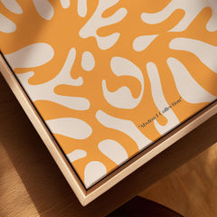 Matisse Art Prints - Orange Abstract Coral Pattern Poster showcased on a wooden frame with bold orange and white patterns.