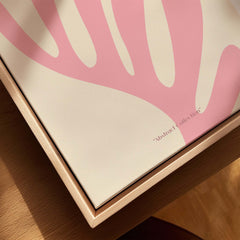 Matisse Art Prints - Pink Coral Leaf Abstract Botanical Poster displayed in a wooden frame with a warm beige background.