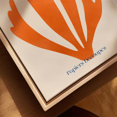 Matisse Papiers Découpés Orange Abstract Botanical Cut Out Art Print displayed on a wooden surface.
