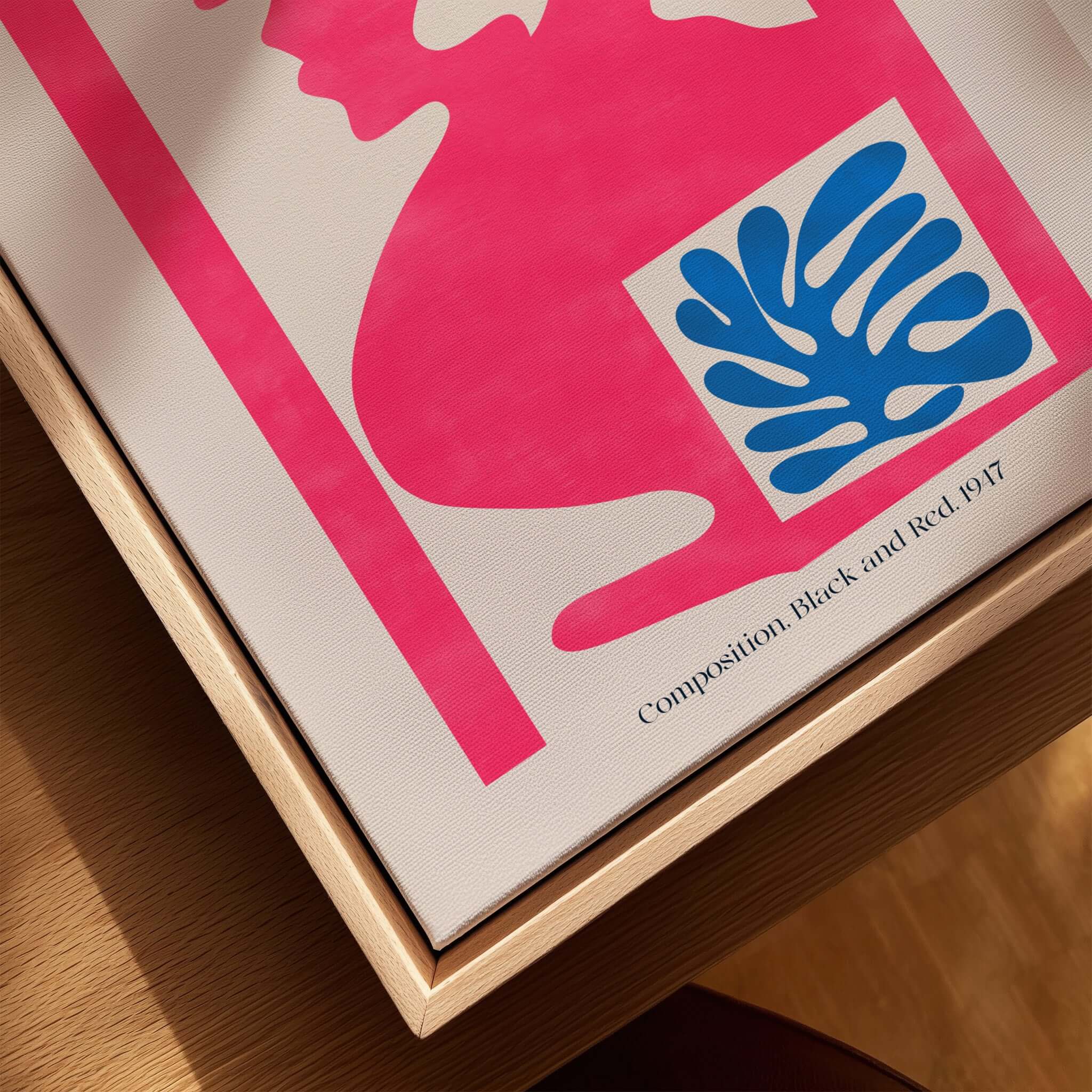 Matisse Art Print Composition Pink Blue Abstract Cut Out Print 1947 on a wooden table showing vibrant colors and shapes.