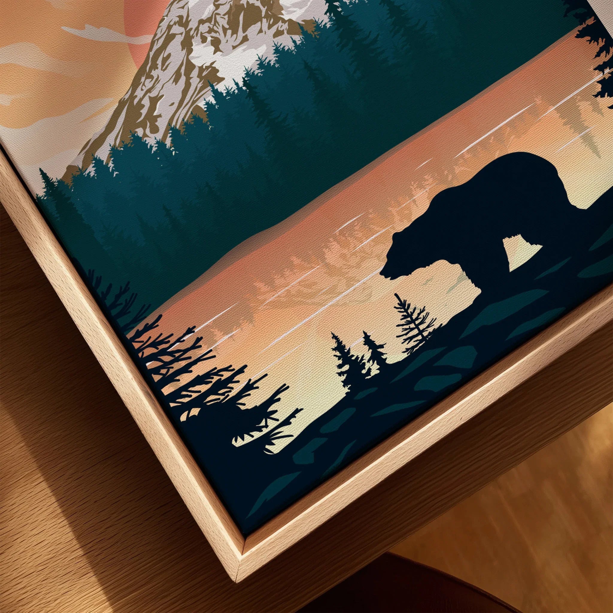Framed canvas art with bear silhouette, mountain, and forest at sunset, close-up view