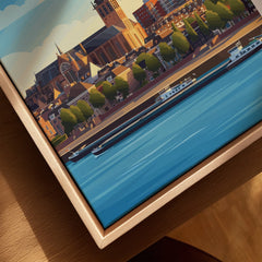Close-up of framed city skyline wall art print with river and buildings, natural wood frame.