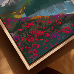 Close-up of framed canvas art with wildflowers, mountains, lake, and natural wood frame