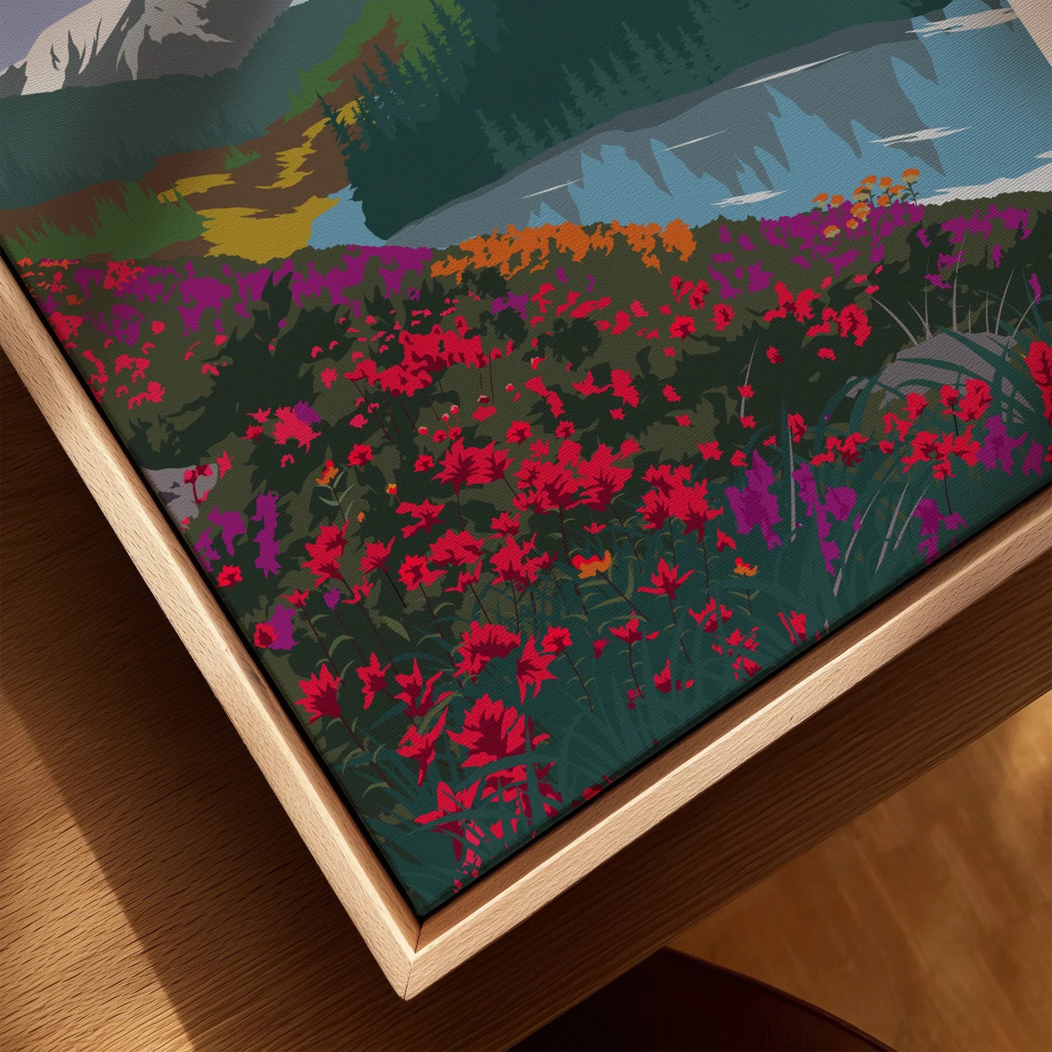 Close-up of framed canvas art with wildflowers, mountains, lake, and natural wood frame