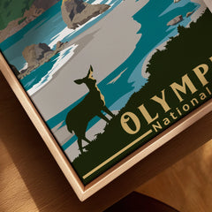 Close-up of framed canvas wall art featuring a deer, coastal scene, and Olympic National Park text.