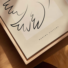 Picasso Dove of Peace Olive Branch Line Art Poster Modern Gallery Print displayed on a wooden surface.
