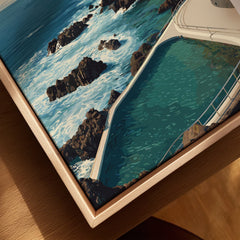 Close-up of framed canvas print showing an ocean pool, natural rocks, and turquoise water.