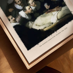 Rembrandt Anatomy Lesson Dr Tulp 1632 Group Portrait Art Print Dutch Master Poster displayed on wooden surface.